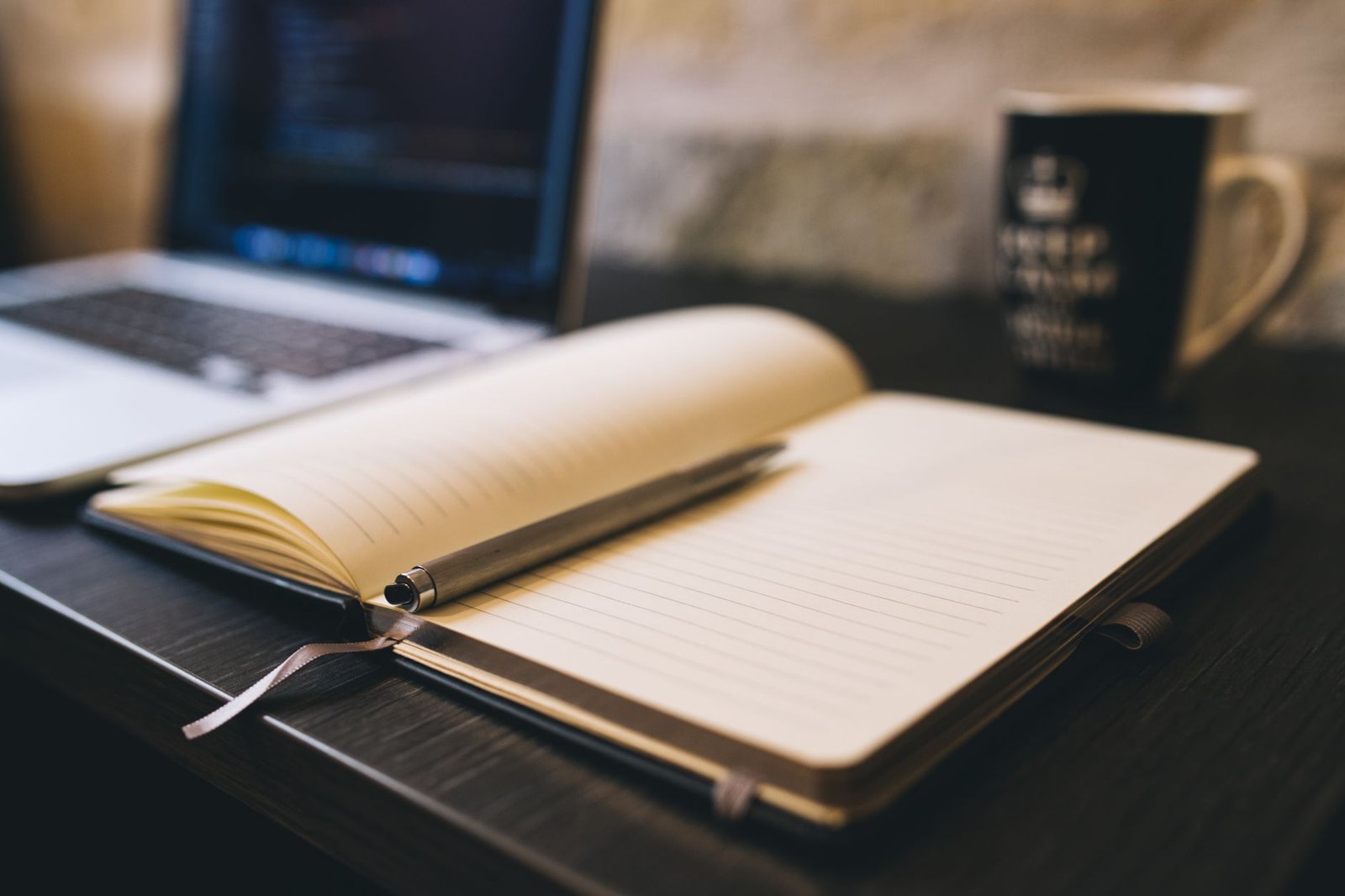 Open notebook and pen on a desk