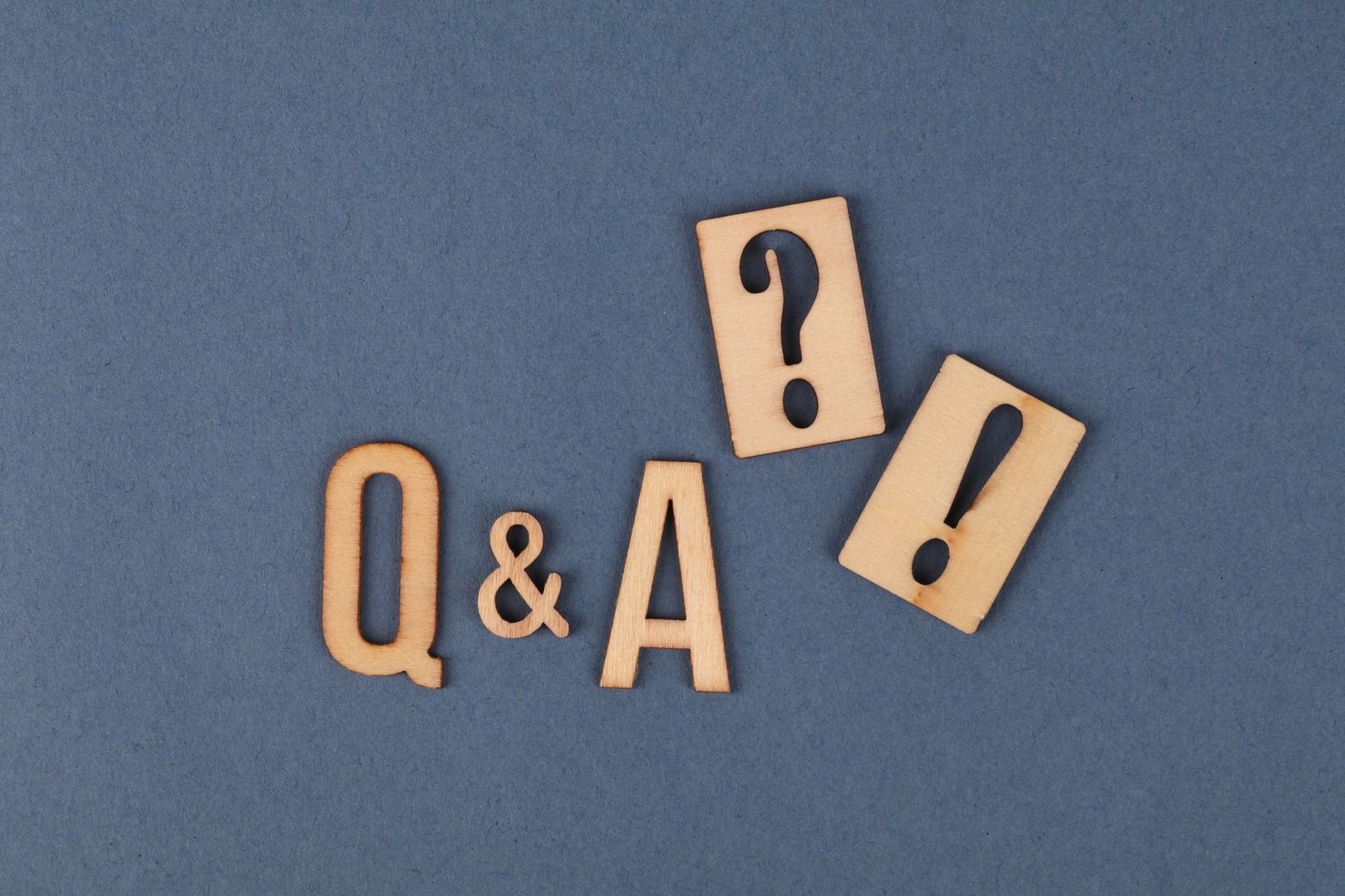 Wooden Q and A letter tiles, representing frequently asked questions